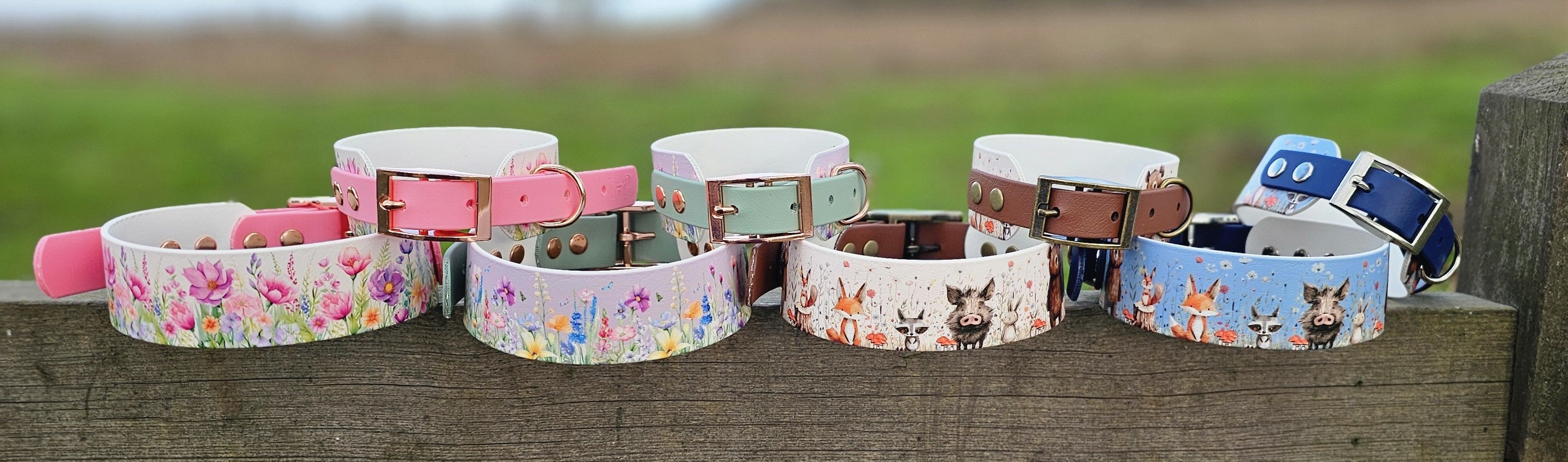 Collection of colorful dog collars on a wooden surface with a natural background