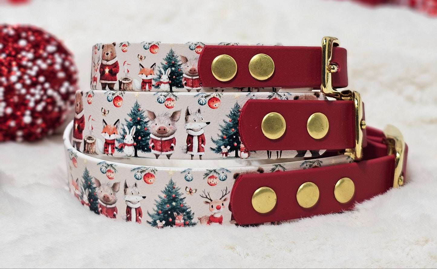 Two dog collars with festive patterns and gold studs against a blurred Christmas tree background.
